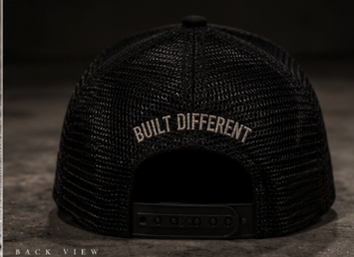 Back view of the Mavazi hat showing the mesh construction and Built Different embroidery above the snapback closure