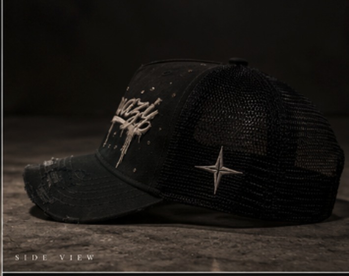 Side view of the Mavazi hat showing the distressed brim, mesh panel and four-point star detail