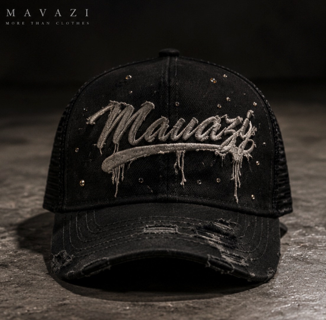 Front view of the black distressed Mavazi trucker hat with silver script embroidery and metallic studs