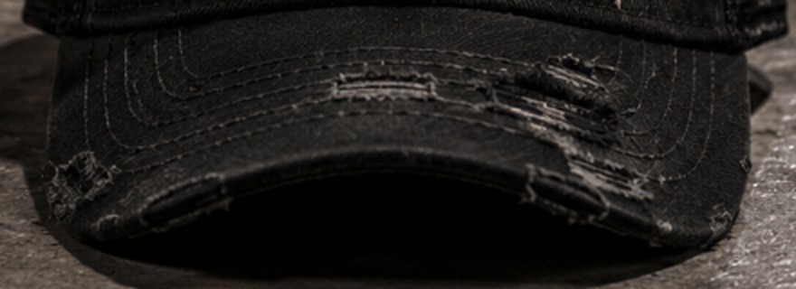 Close-up of the hand-distressed brim edge and frayed stitching
